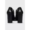 Black leather ankle boots with a zipper