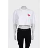 White top with a signature brooch