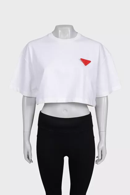White top with a signature brooch