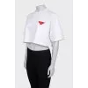 White top with a signature brooch