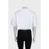 White top with a signature brooch