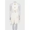 White sleeveless dress with chunky buttons