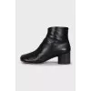 Black leather ankle boots with a square toe