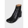 Black leather ankle boots with a square toe