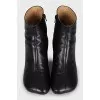 Black leather ankle boots with a square toe