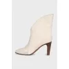 Ankle boots with a shaped top