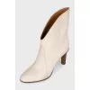 Ankle boots with a shaped top