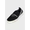 Textile slip-ons with a signature print