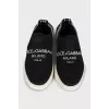 Textile slip-ons with a signature print