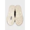 Textile slip-ons with a signature print