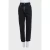 Black rolled-up jeans with a belt