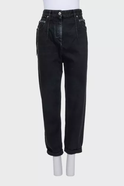 Black rolled-up jeans with a belt