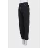 Black rolled-up jeans with a belt