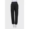 Black rolled-up jeans with a belt