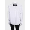 The white shirt is decorated with crystals