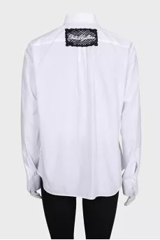 The white shirt is decorated with crystals
