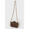 Bag with feathers on a metal chain