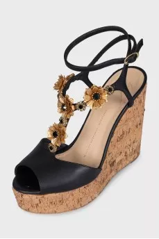 Black sandals with metallic flowers