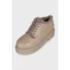 Beige fur-lined boots with a tag