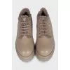 Beige fur-lined boots with a tag