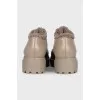 Beige fur-lined boots with a tag