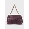 Purple bag with a gold clasp