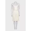 White dress with a pleated skirt