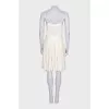 White dress with a pleated skirt