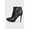 Leather ankle boots with heels and a gold zipper