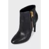 Leather ankle boots with heels and a gold zipper