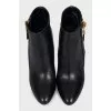 Leather ankle boots with heels and a gold zipper