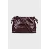 Burgundy bag with a magnetic closure