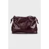 Burgundy bag with a magnetic closure