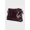Burgundy bag with a magnetic closure