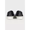Blue leather slip-ons with decor