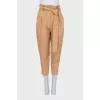Beige tapered trousers with a belt