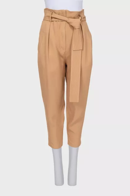 Beige tapered trousers with a belt