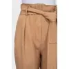 Beige tapered trousers with a belt