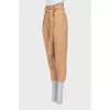 Beige tapered trousers with a belt