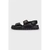 Black leather sandals with gold hardware