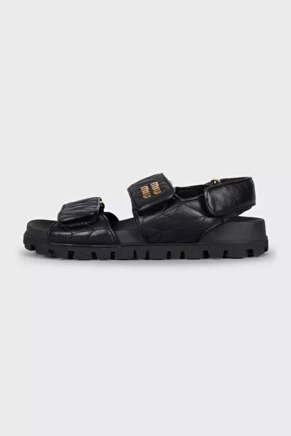 Black leather sandals with gold hardware