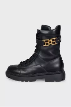 Leather boots with a gold brand logo