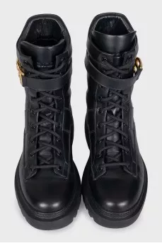 Leather boots with a gold brand logo