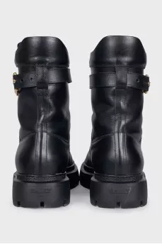 Leather boots with a gold brand logo