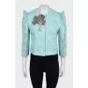 A shimmery jacket with accent shoulders