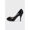 Black patent leather shoes with gold hardware
