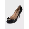 Black patent leather shoes with gold hardware