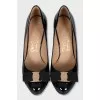 Black patent leather shoes with gold hardware