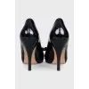 Black patent leather shoes with gold hardware