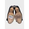 Black patent leather shoes with gold hardware